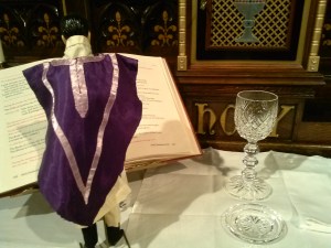 Fr. Kenny, brushing up on prayer D before service.