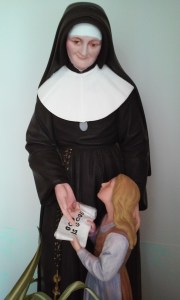 St. Julie teaches a child.